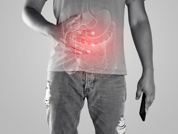 Man with hands on stomach, illustration highlighting digestive tract