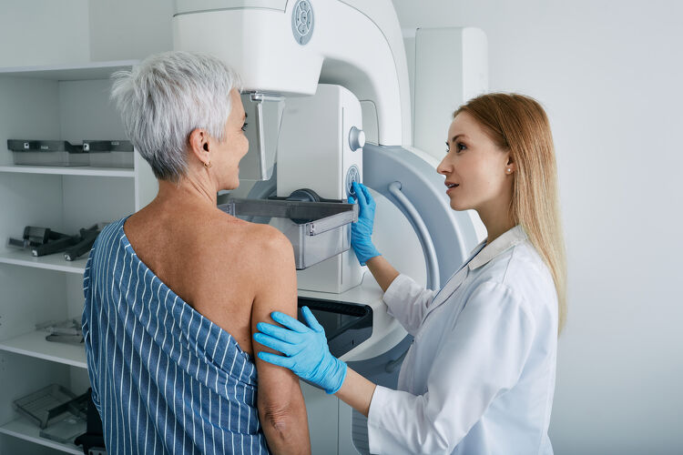 Doctor helping patient during a mammogram screening